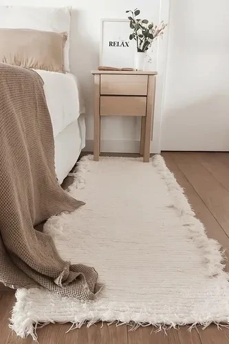 Small cream woven cotton runner rug with fringed ends, 110 x 60 cm