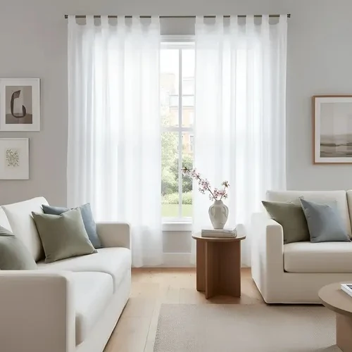 Pair of floor-length white translucent voile curtains