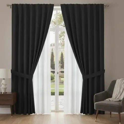 Black blackout curtain pair layered over white sheer voile, with tiebacks