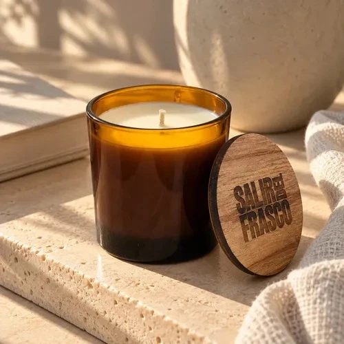 Soy candle in an amber glass tumbler with a round engraved wooden lid