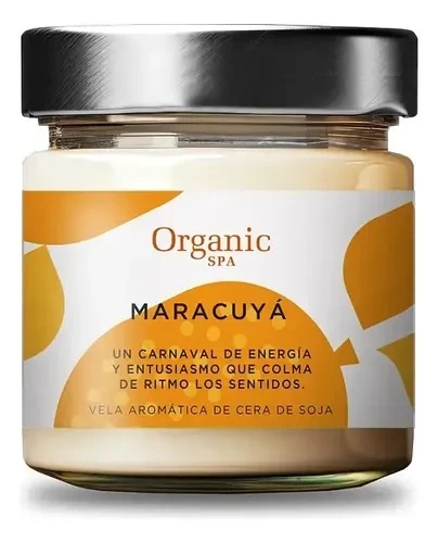 Soy candle in a squat clear jar with black screw lid and orange-and-white label