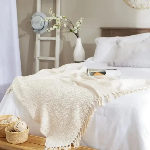 Cream textured woven throw with tasseled fringe, 160 x 100 cm