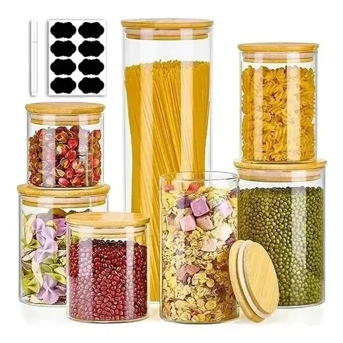 Set of seven clear glass jars in graduated heights with bamboo lids